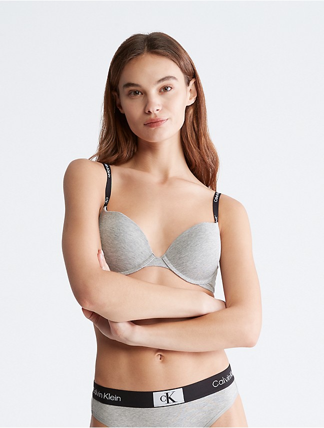 Lady with choice trying to choose perfect bra. Stock Photo by