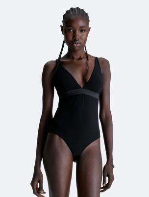 Calvin Klein - The one-piece suit. Coral Kwayie wearing the Intense Power  Scoopneck Swimsuit. Made with 78% sustainably-sourced recycled nylon.  Finished with a bold logo on the chest, signature logo straps, and